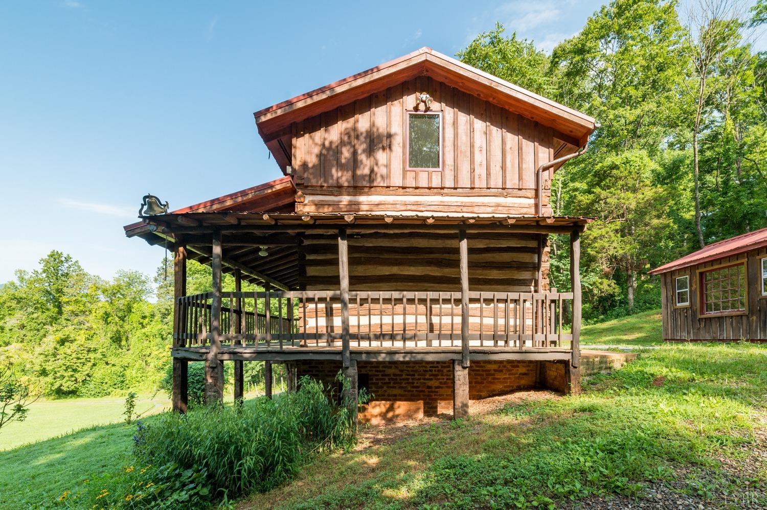 704 Peters Hollow Road Monroe, VA 24574 - Photo 1 of 55 a front view of a house with garden