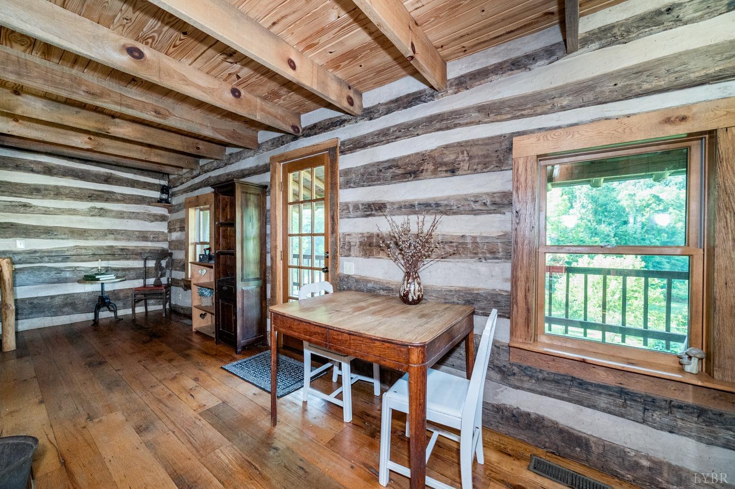 704 Peters Hollow Road Monroe, VA 24574 - Photo 13 of 55 a view of a dining room with furniture window and wooden floor