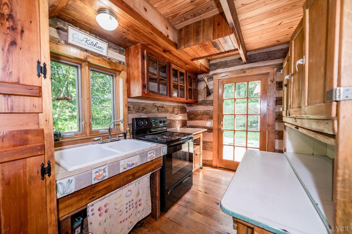 704 Peters Hollow Road Monroe, VA 24574 - Photo 14 of 55 a kitchen with stainless steel appliances granite countertop a stove and a refrigerator
