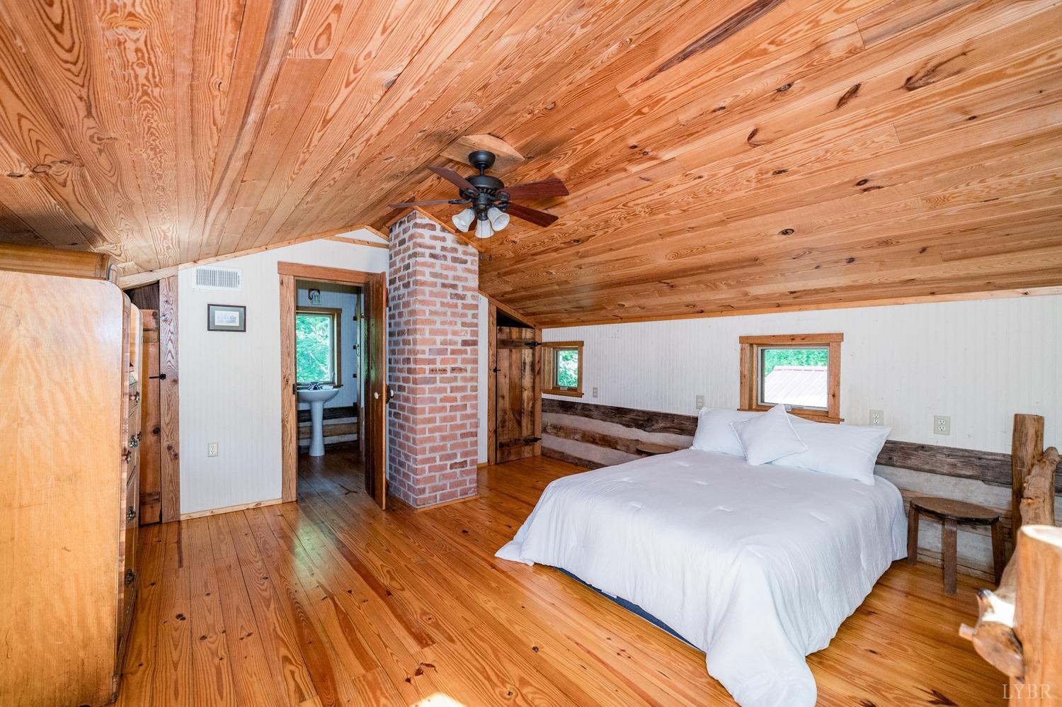 704 Peters Hollow Road Monroe, VA 24574 - Photo 20 of 55 a bedroom with furniture and wooden floor