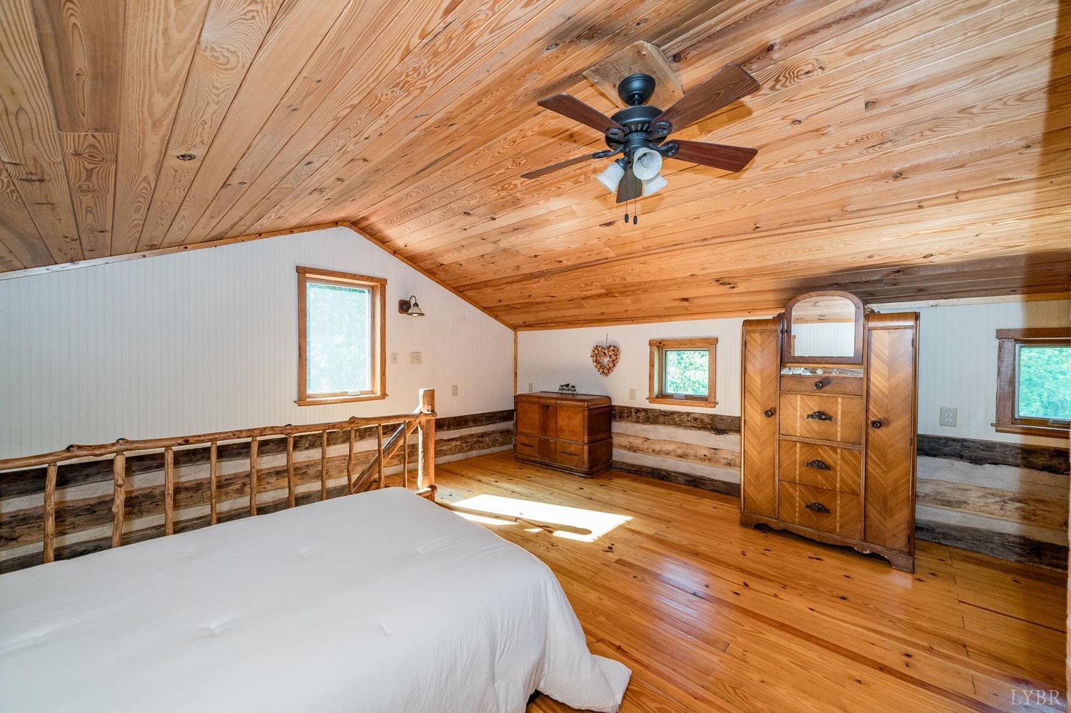 704 Peters Hollow Road Monroe, VA 24574 - Photo 21 of 55 a bedroom with furniture and wooden floors