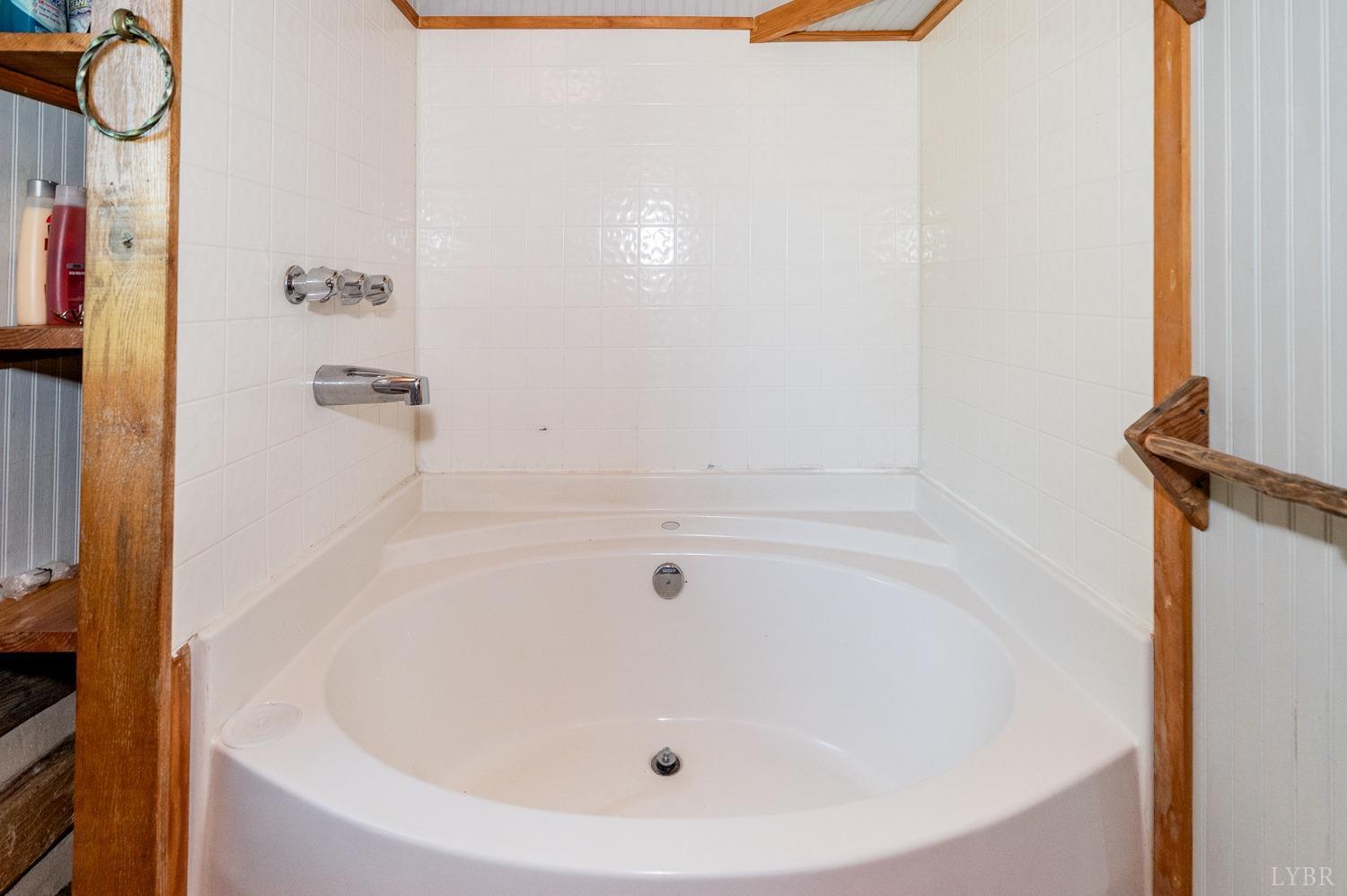 704 Peters Hollow Road Monroe, VA 24574 - Photo 23 of 55 a white bath tub sitting next to a shower