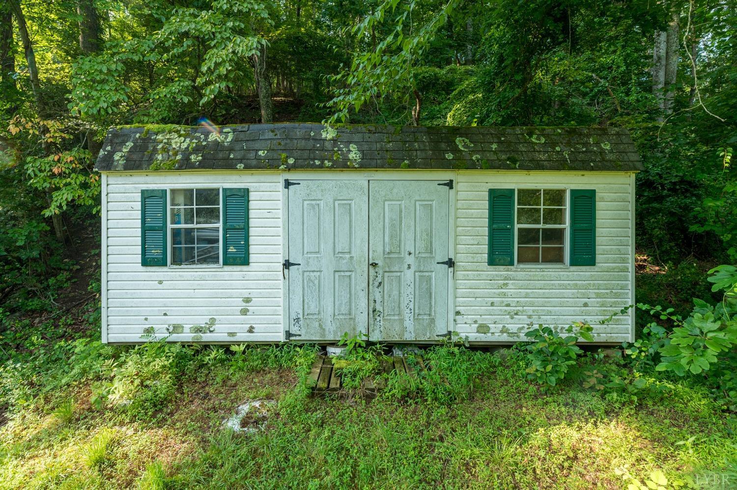 704 Peters Hollow Road Monroe, VA 24574 - Photo 38 of 55 a front view of a house with a garden