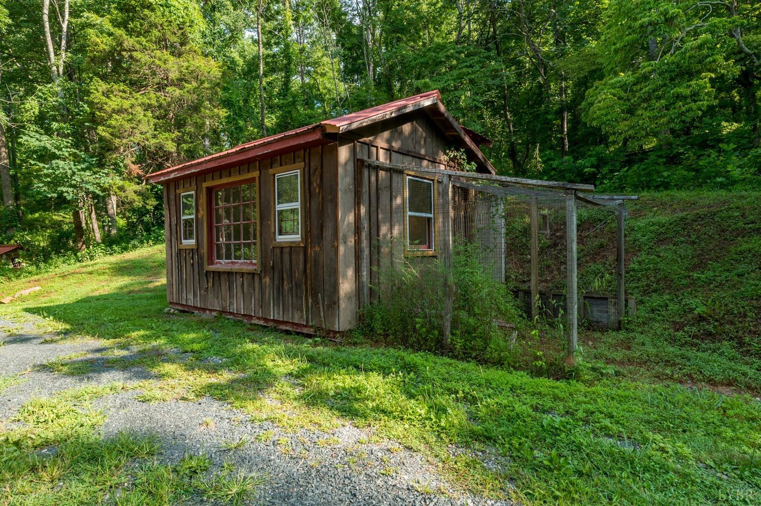 704 Peters Hollow Road Monroe, VA 24574 - Photo 39 of 55 a view of a small house with a small yard and large trees