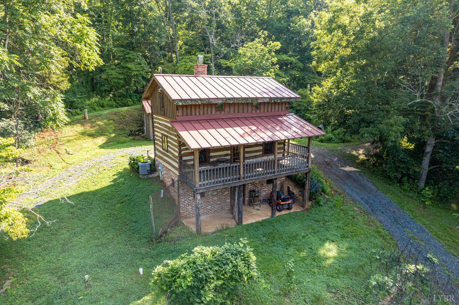 704 Peters Hollow Road Monroe, VA 24574 - Photo 42 of 55 a view of a wooden deck and a yard with the trees