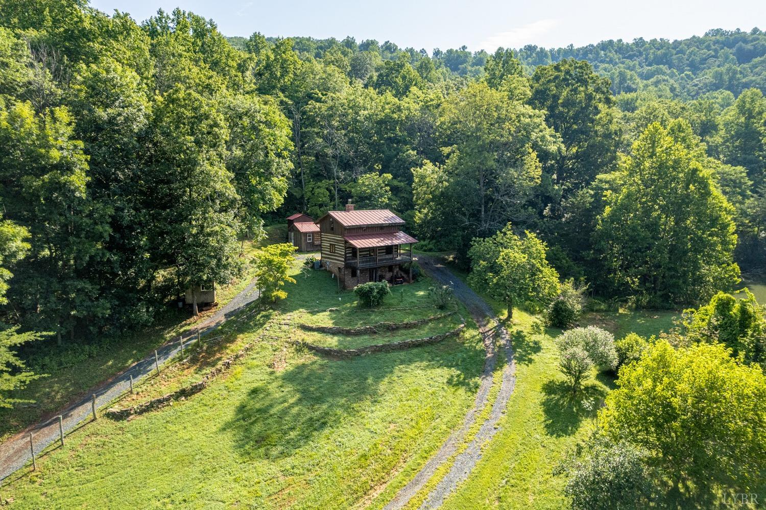 704 Peters Hollow Road Monroe, VA 24574 - Photo 44 of 55 a view of a garden with a lake