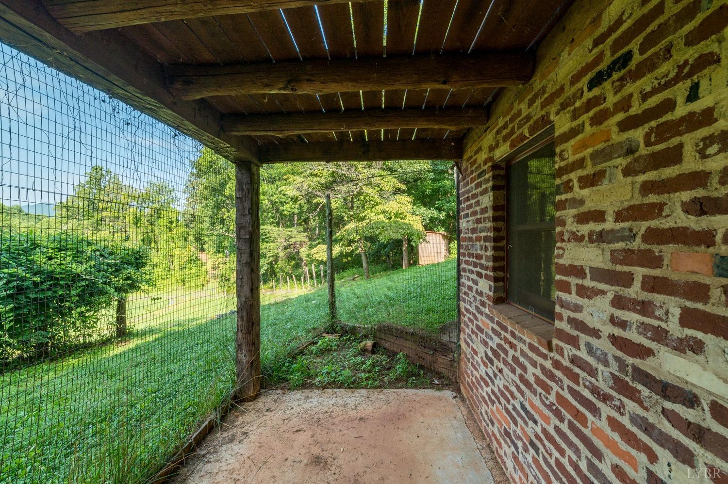 704 Peters Hollow Road Monroe, VA 24574 - Photo 7 of 55 a view of a porch with wooden floor