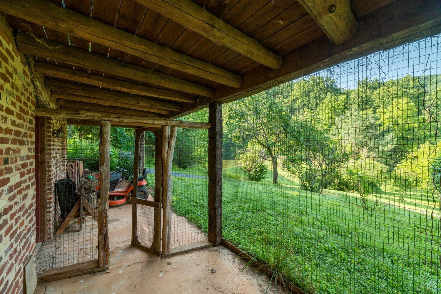 704 Peters Hollow Road Monroe, VA 24574 - Photo 8 of 55 a view of a porch with furniture and garden