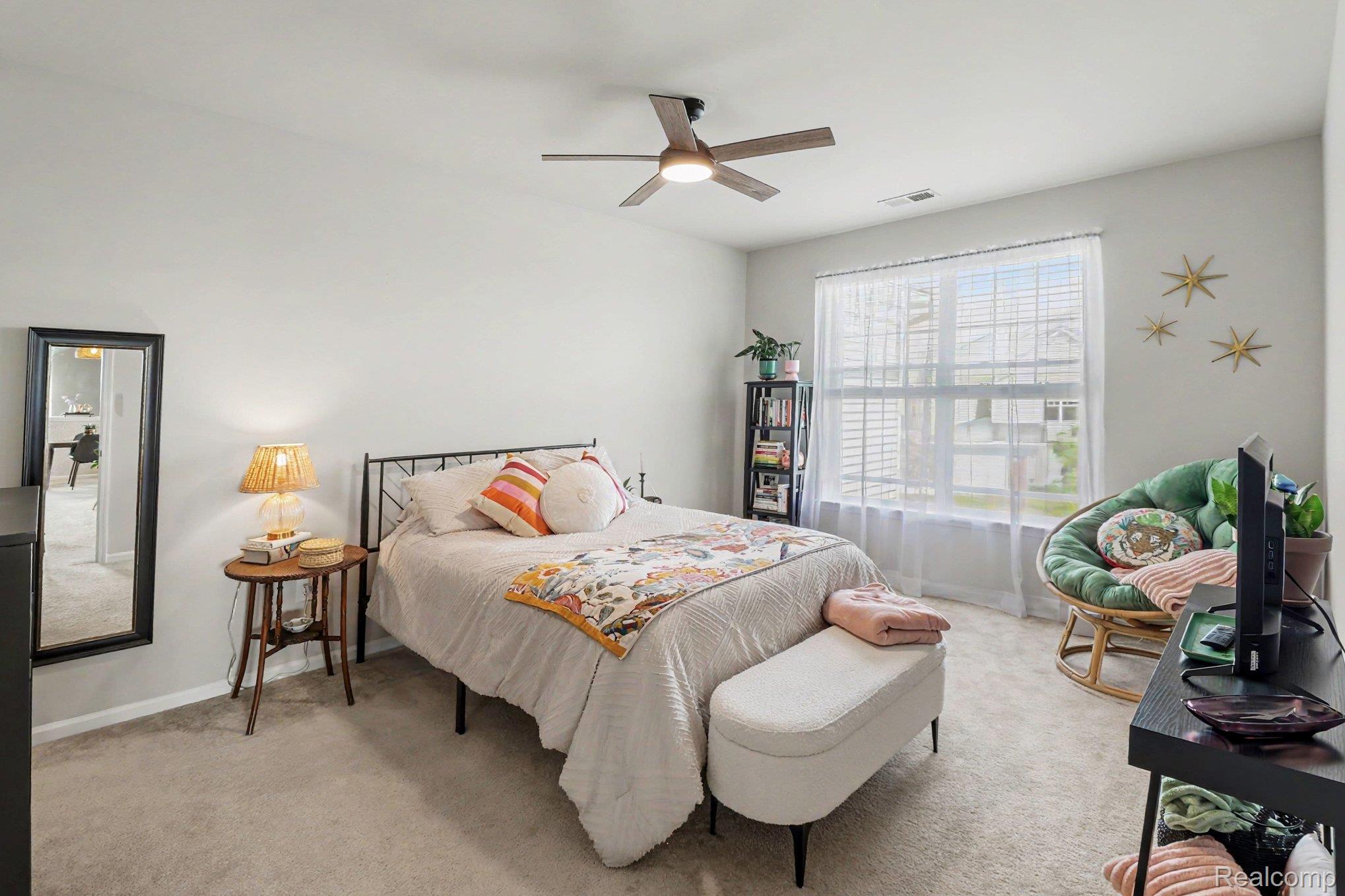 9864 Ridge Run Street Howell, MI 48855 - Photo 15 of 23 Bedroom featuring light carpet and a ceiling fan