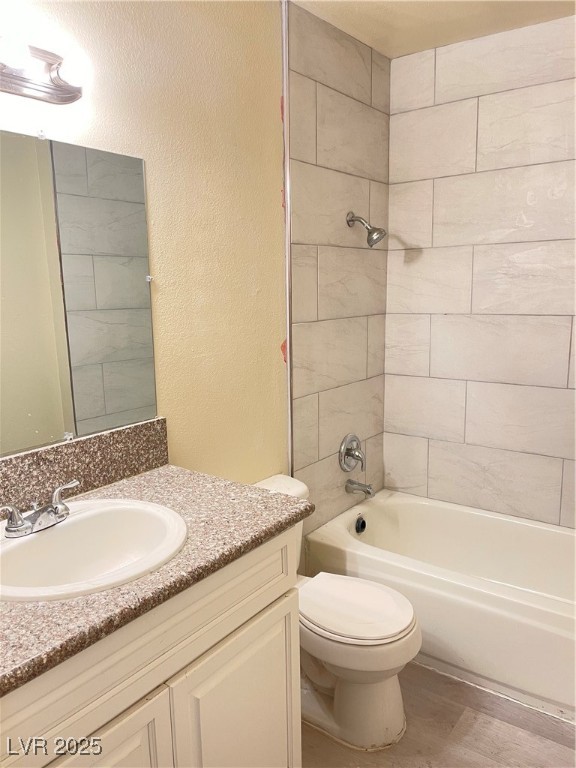 1709 Fairfield Avenue, Unit G Las Vegas, NV 89102 - Photo 7 of 15 Full bathroom with shower / washtub combination, vanity, a textured wall, and wood finished floors