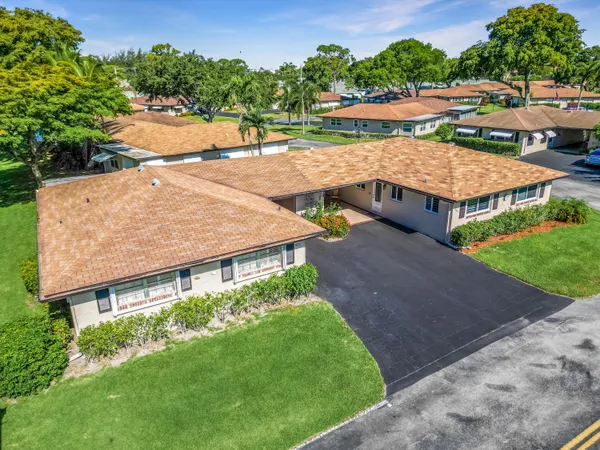 an aerial view of a house with a yard and lake view
