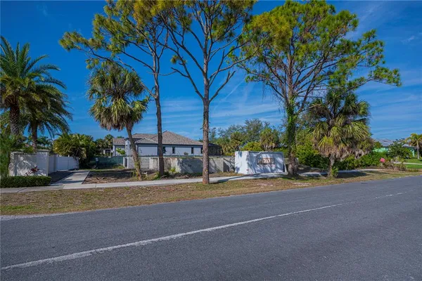 a view of street with a building and a palm tree