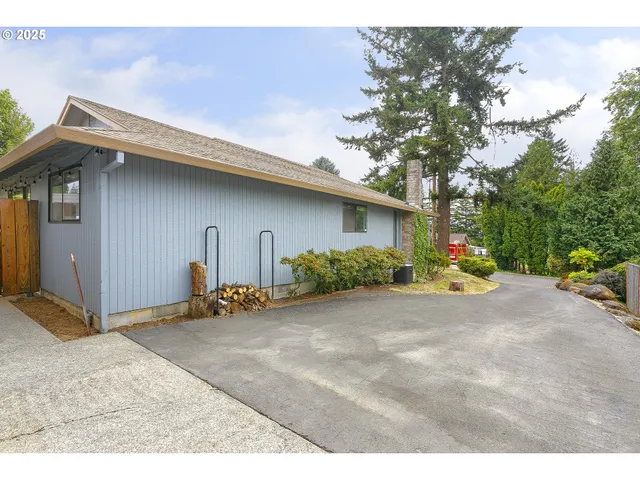 a backyard of a house with table and chairs