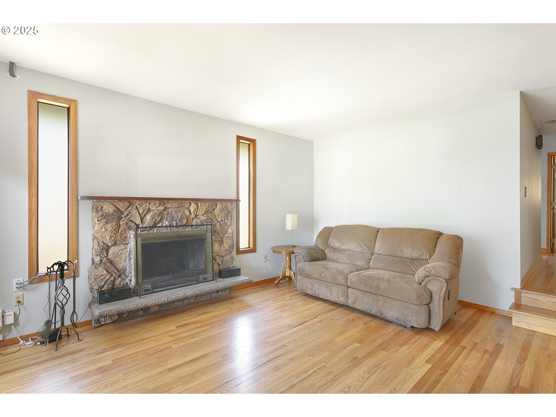 132 Southeast 214th Avenue Gresham, OR 97030 - Photo 3 of 27 a living room with furniture and a fireplace
