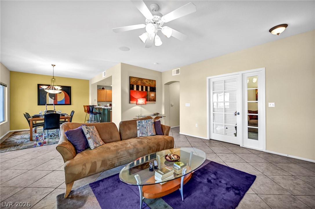 10730 Amber Ridge Drive, Unit 101 Las Vegas, NV 89144 - Photo 8 of 32 An open-concept living area with abundant lighting seamlessly connects to a chic dining space.