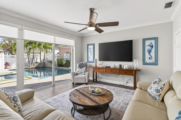 a living room with furniture flat screen tv and wooden floor