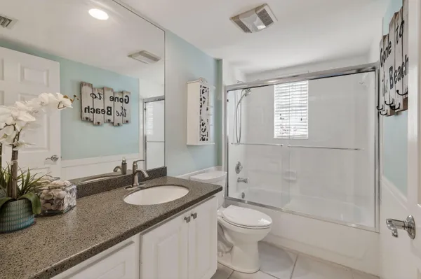 a kitchen with granite countertop a sink and a stove
