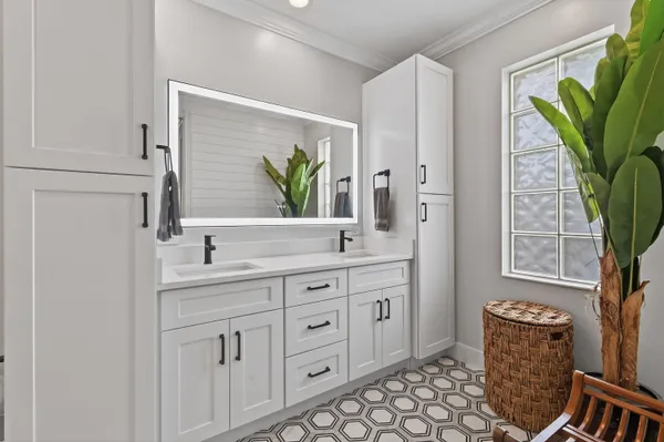 a room with white cabinets and wooden floor