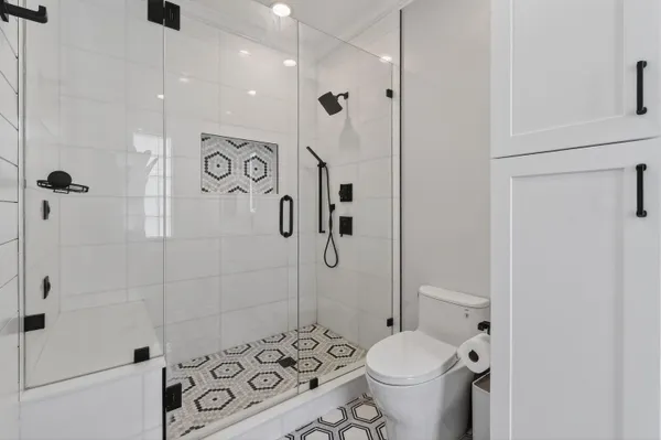 a bathroom with a toilet sink vanity and mirror