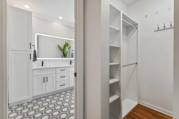 a view of a hallway with wooden floor windows and a livingroom