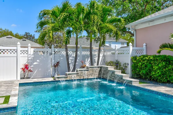 a view of a house with pool plants and outdoor seating