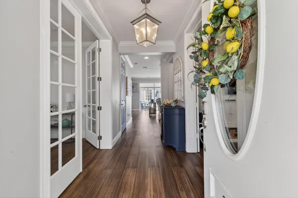 a view of a livingroom with wooden floor and a chandelier