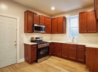 6016 South Carpenter Street Chicago, IL 60621 - Photo 11 of 15 a kitchen with stainless steel appliances granite countertop wooden cabinets a stove top oven a sink and dishwasher