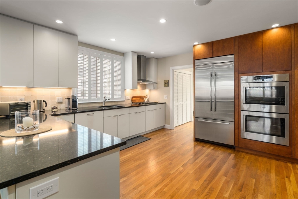 16 York Terrace Brookline, MA 02446 - Photo 13 of 42 a kitchen with stainless steel appliances granite countertop a refrigerator a sink and a stove