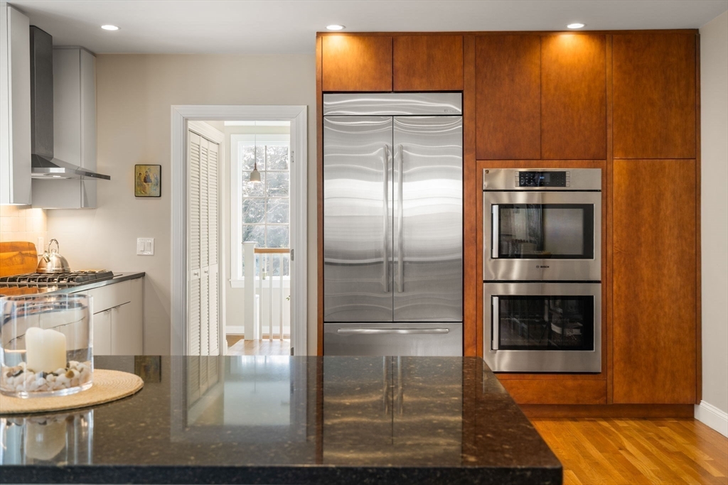 16 York Terrace Brookline, MA 02446 - Photo 16 of 42 a kitchen with granite countertop stainless steel appliances and wooden cabinets