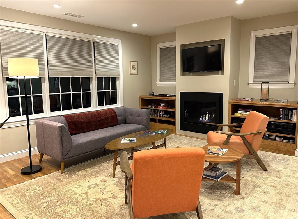 16 York Terrace Brookline, MA 02446 - Photo 26 of 42 a living room with furniture a fireplace and a flat screen tv