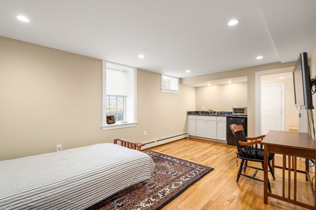 16 York Terrace Brookline, MA 02446 - Photo 36 of 42 a bedroom with a bed and a table in it
