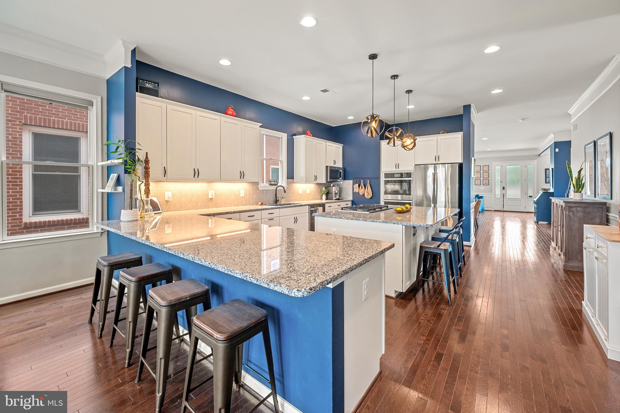 8459 Reformatory Way Lorton, VA 22079 - Photo 21 of 78 an open kitchen with a table and chairs in it