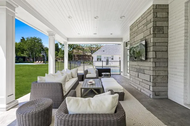a view of a patio with a table chairs and a backyard