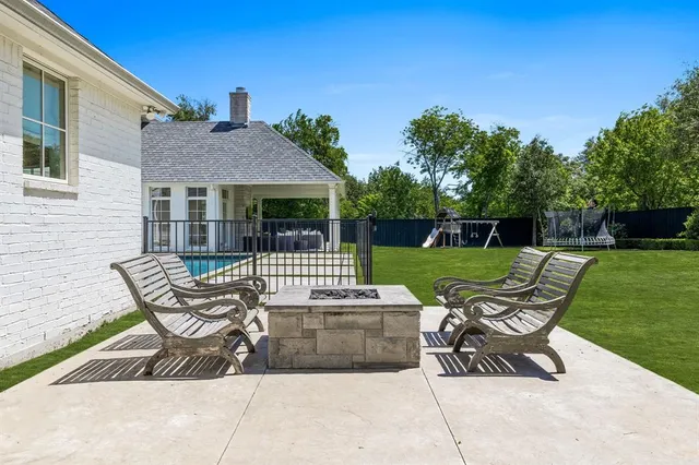 an aerial view of a house with a yard and large trees