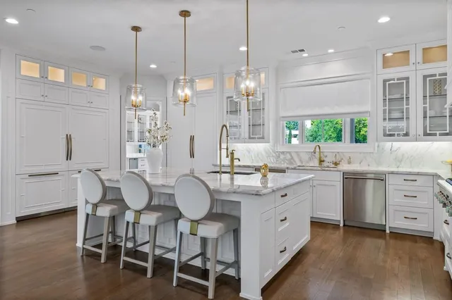 a large kitchen with kitchen island a island a sink stainless steel appliances and cabinets
