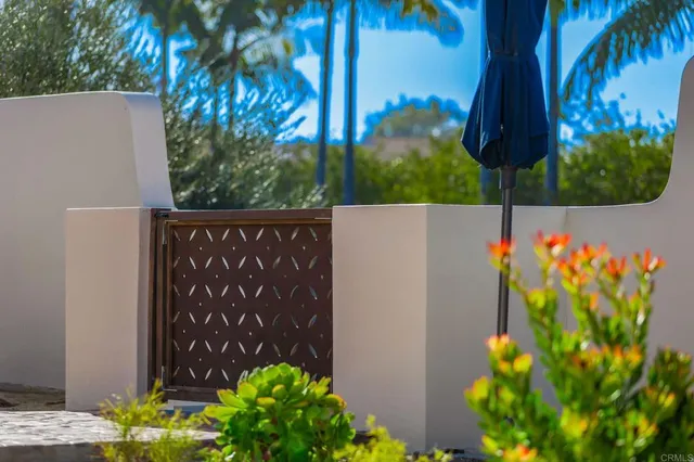 a view of a sign in a yard with potted plants