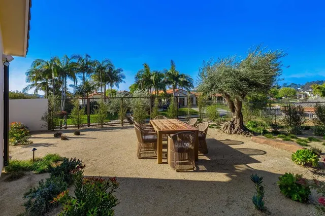 a view of a backyard with sitting area