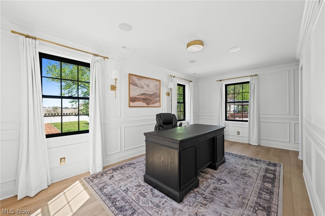 25870 Kennedy Ridge Road North Olmsted, OH 44070 - Photo 26 of 50 Bright room featuring two large windows, extensive wainscoting, light wood-finish flooring, and recessed ceiling speakers
