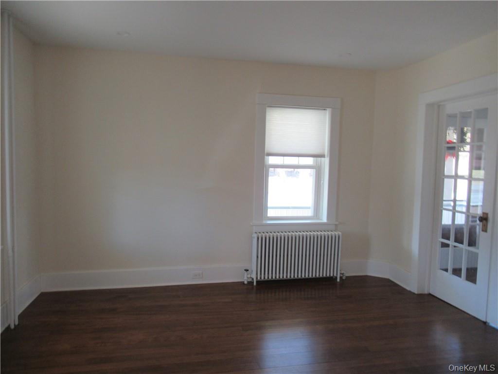 198 Big Island Road Warwick, NY 10990 - Photo 11 of 24 an empty room with wooden floor and windows