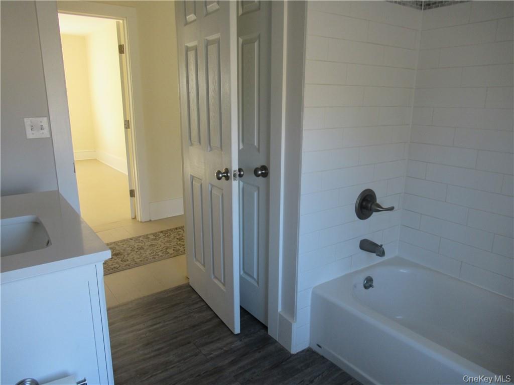 198 Big Island Road Warwick, NY 10990 - Photo 18 of 24 a bathroom with a tub a sink and wooden floor