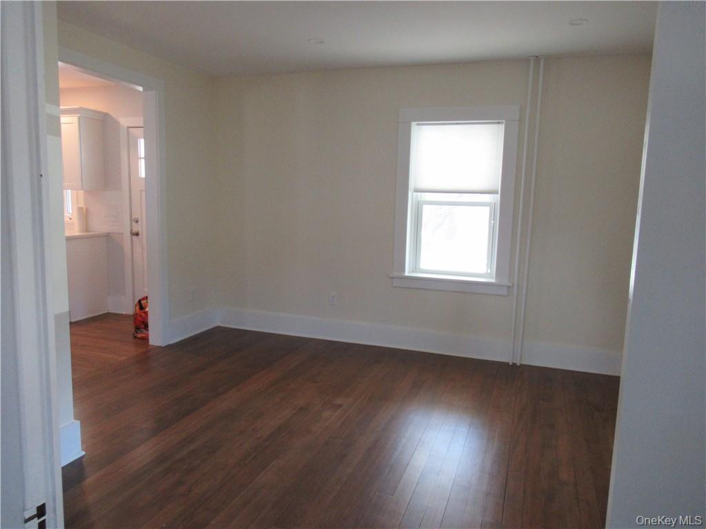 198 Big Island Road Warwick, NY 10990 - Photo 9 of 24 an empty room with wooden floor and windows