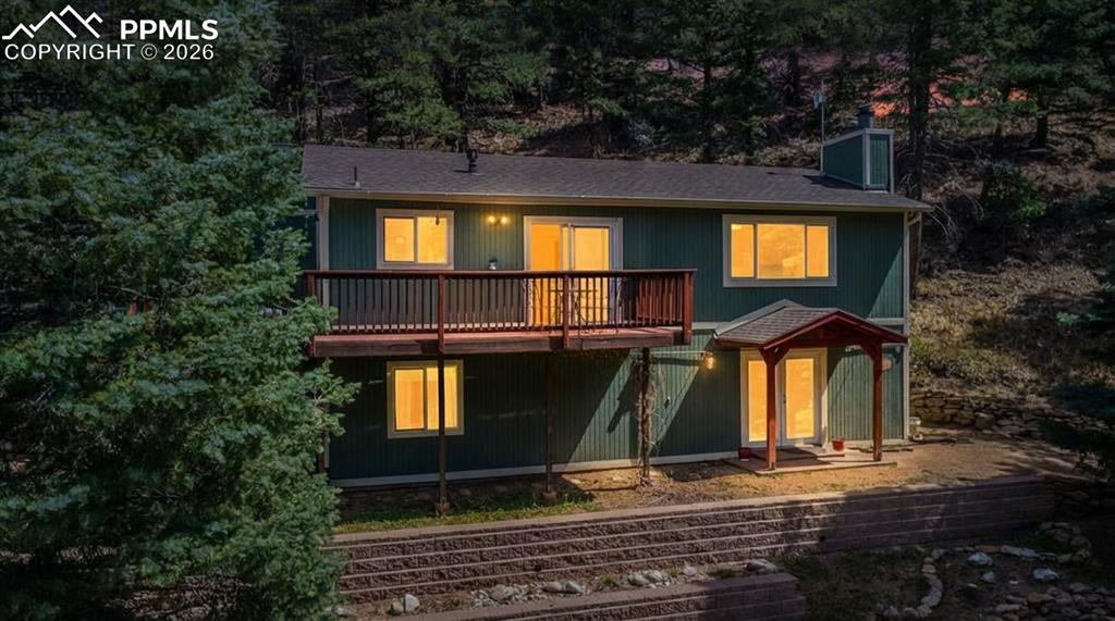 5130 Neeper Valley Road Manitou Springs, CO 80829 - Photo 1 of 38 a view of a house with backyard and trees