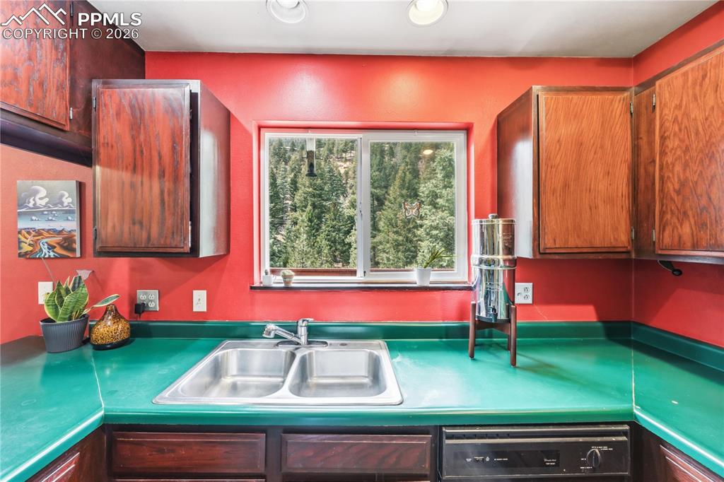 5130 Neeper Valley Road Manitou Springs, CO 80829 - Photo 15 of 38 a kitchen that has a sink and a large window