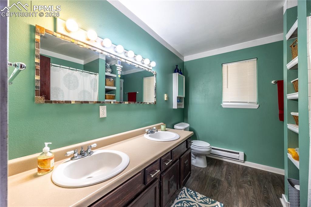 5130 Neeper Valley Road Manitou Springs, CO 80829 - Photo 18 of 38 a bathroom with a sink a toilet and mirror