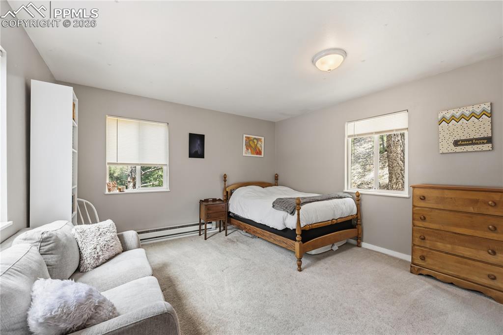 5130 Neeper Valley Road Manitou Springs, CO 80829 - Photo 19 of 38 a bedroom with a bed and window