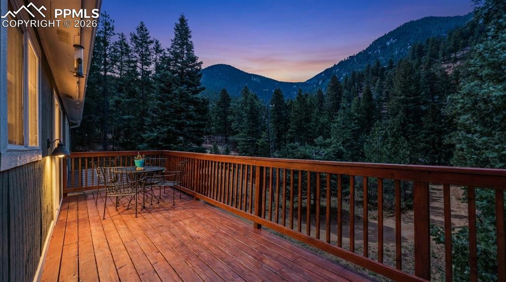 5130 Neeper Valley Road Manitou Springs, CO 80829 - Photo 2 of 38 a balcony with wooden floor and outdoor space