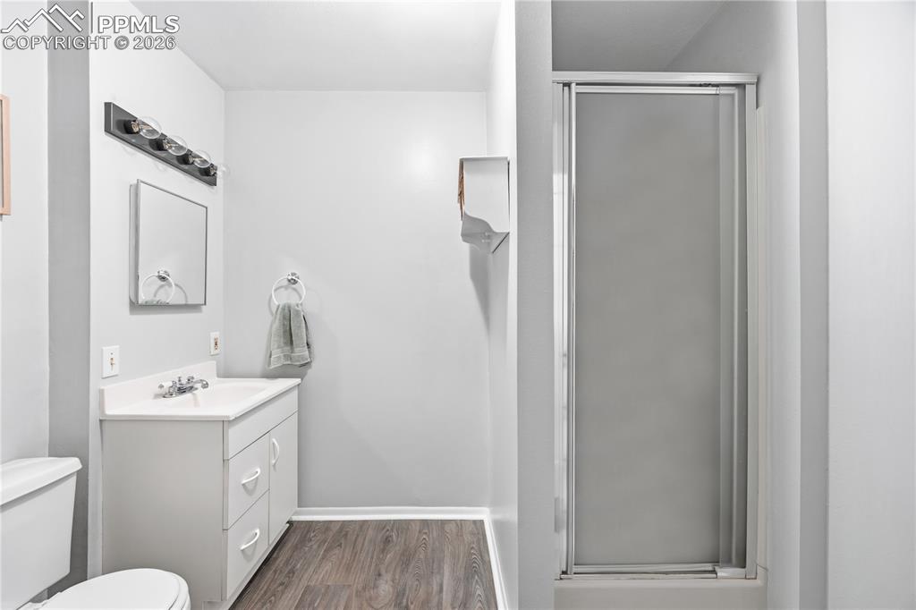 5130 Neeper Valley Road Manitou Springs, CO 80829 - Photo 28 of 38 a bathroom with a sink a toilet a mirror and vanity