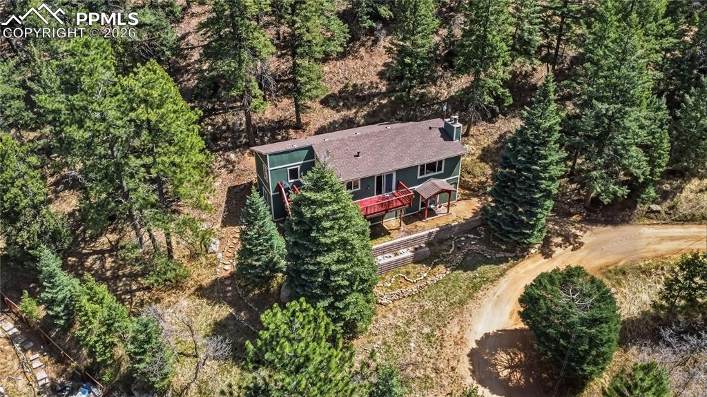 5130 Neeper Valley Road Manitou Springs, CO 80829 - Photo 36 of 38 an aerial view of a house with a yard and large trees