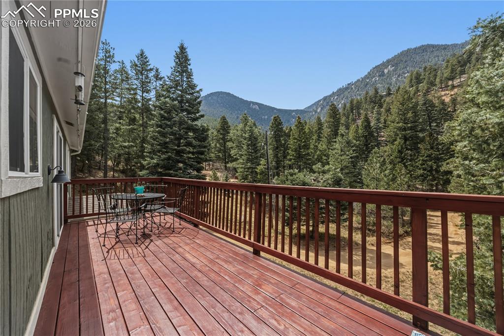 5130 Neeper Valley Road Manitou Springs, CO 80829 - Photo 5 of 38 a balcony with wooden floor and outdoor space