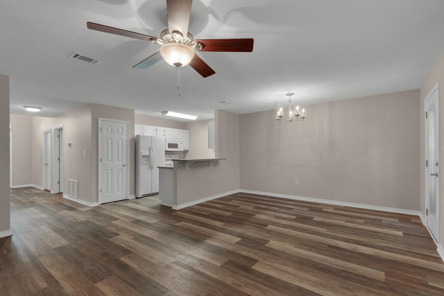 212 Tooke Street, Unit A Fort Walton Beach, FL 32547 - Photo 10 of 26 a view of kitchen and empty room with wooden floor